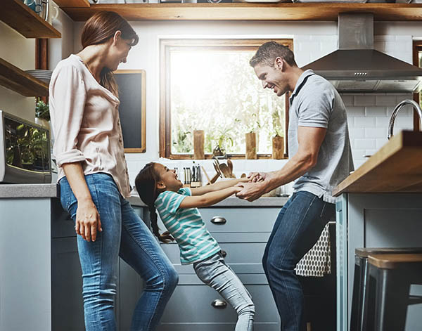 Shot of a family playing together in the kitchen at home