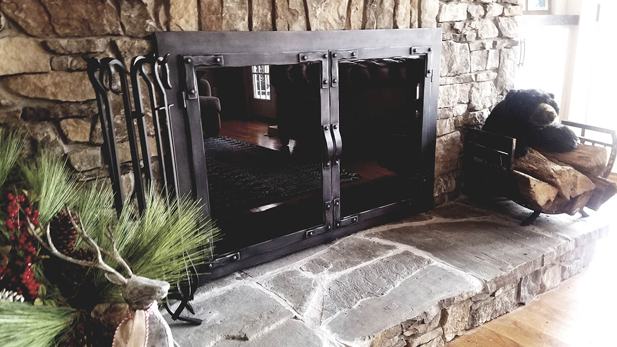 A set of Stoll Industries fireplace doors that provide a fireplace cover for this hearth.