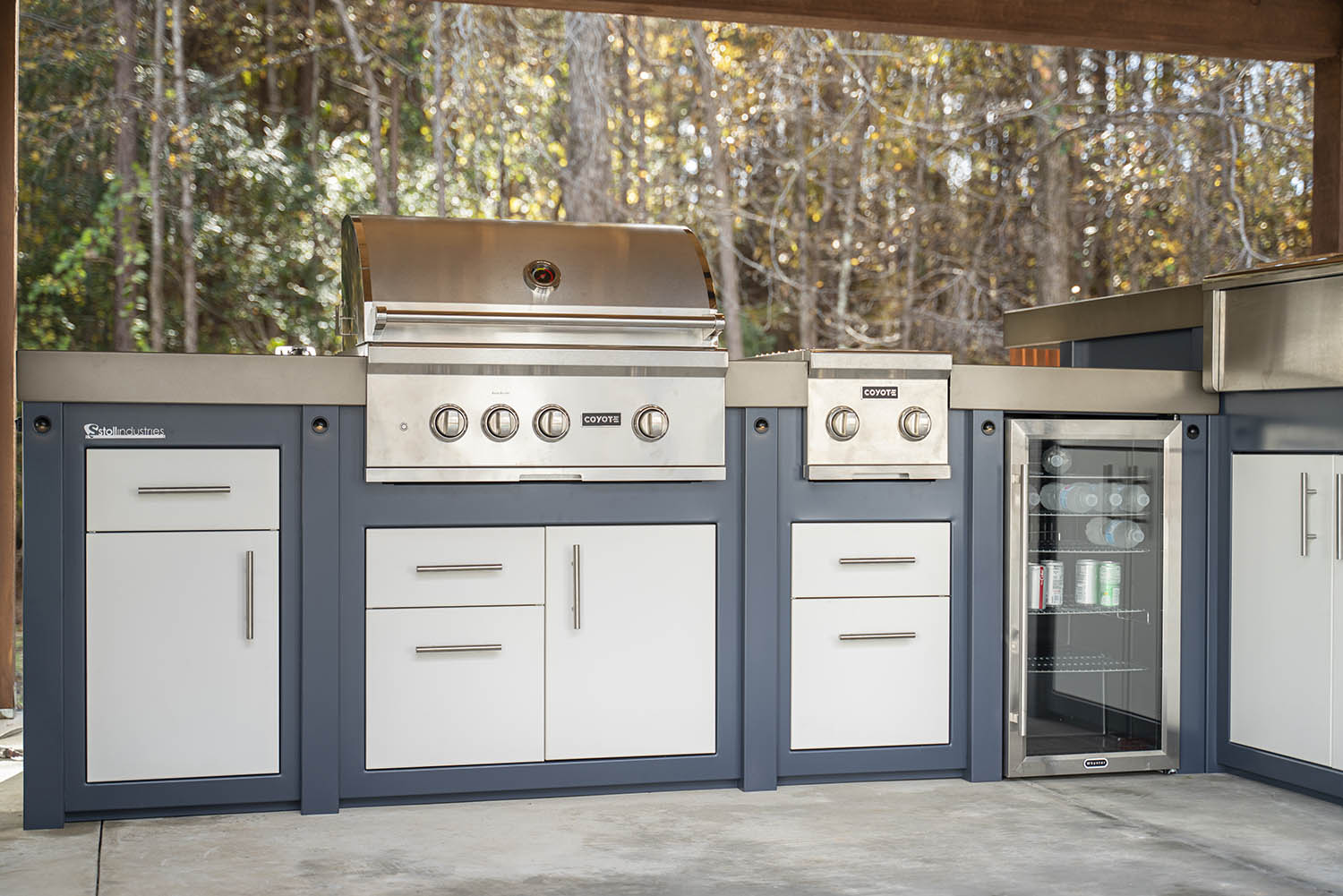 An outdoor kitchen and grill station set up in a backyard living space.