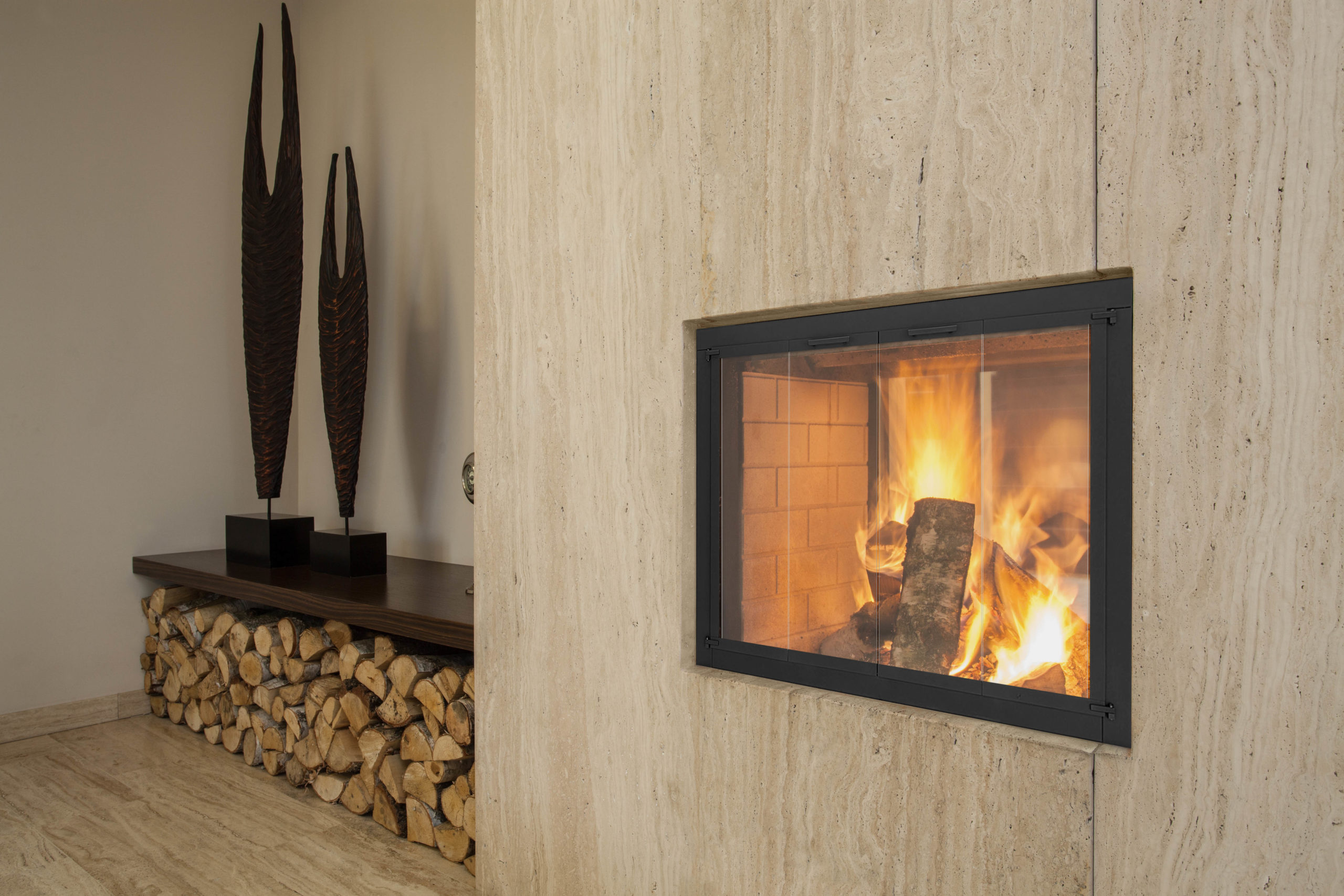 Travertine house: burning fireplace and pieces of wood